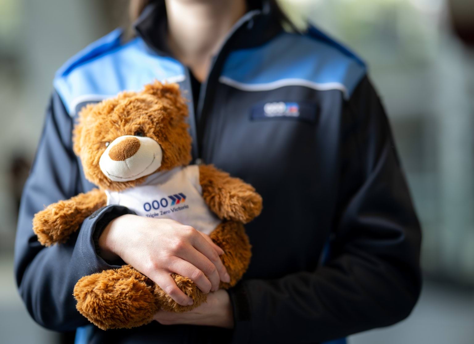 Benny the Bear being held by a Call-Taker