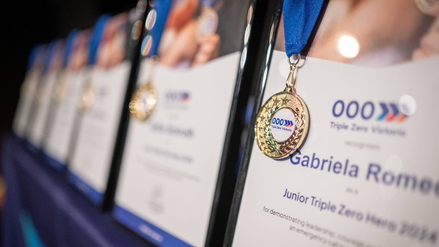A close up shot of the Junior Triple Zero Hero Certificate with medal