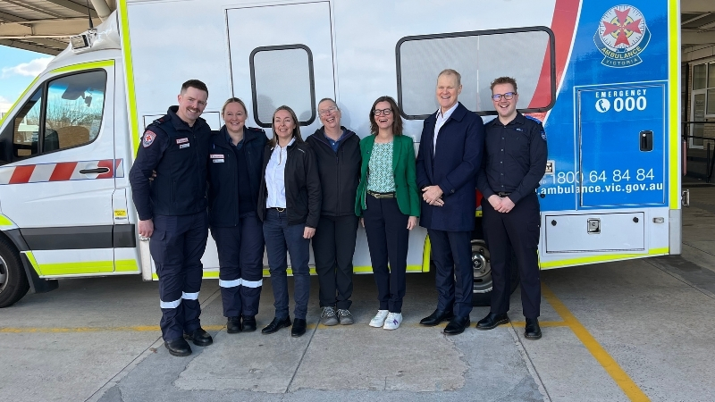 A group shot of paramedics, stoke patient and call taker. 